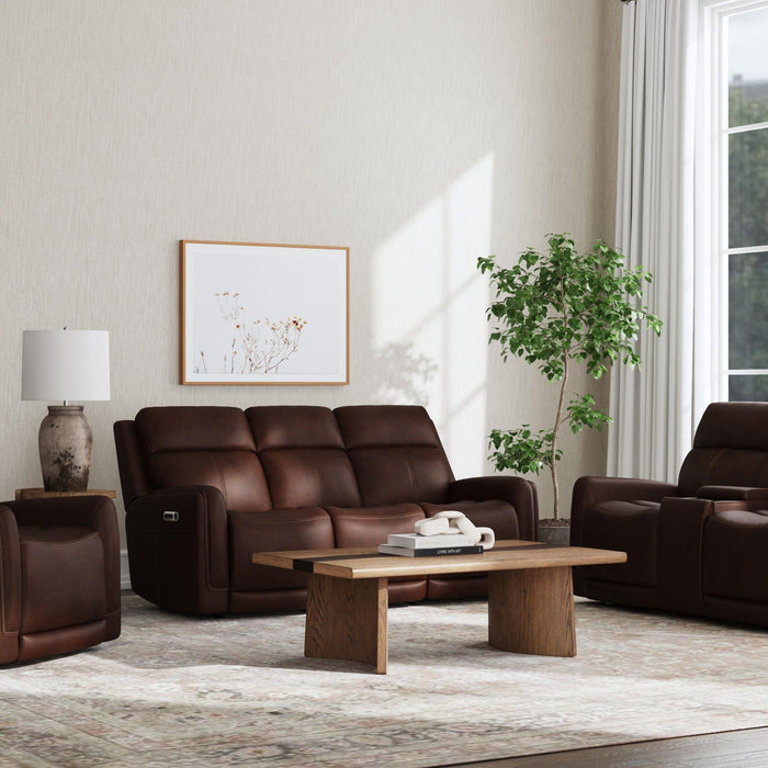 Modern living room featuring brown leather recliner sofas and armchairs arranged around a wooden coffee table, showcasing the latest furniture trend in comfort and contemporary home design.
