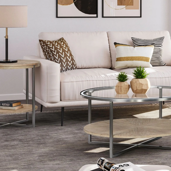 A stylish living room featuring a modern sofa, a glass coffee table, and a wooden side table with a decorative lamp, perfect for your living room table setup.